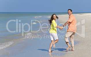 Happy Couple Running Holding Hands on A Beach