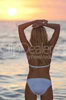 Beautiful Woman in Bikini on Beach At Sunset