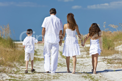 Mother, Father and Children Family Walking At Beach