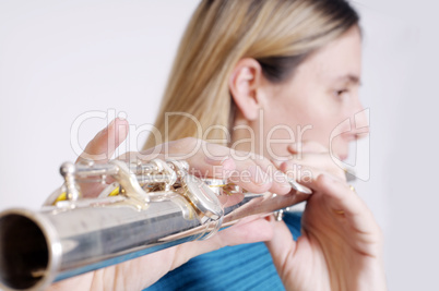 Young woman playing transverse flute