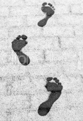 Three barefoot footprints