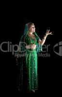 young girl in indian costume look at light