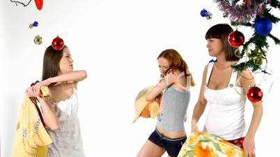 Girls stand and fight with pillow - new year scene