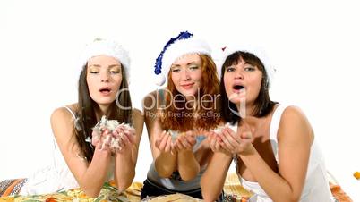 Three girls blow feather on you christmas scene