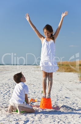 Two Children, Boy and Girl Making Sandcastles on Beach
