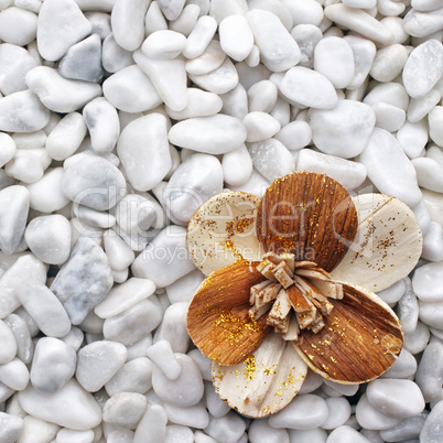 Wooden Flower on white Stones - Wellness Concept