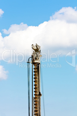 Auger part over blue sky with clouds