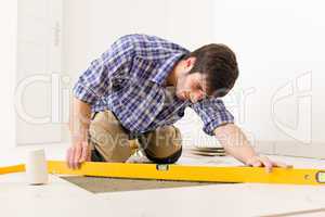 Home tile improvement - handyman with level