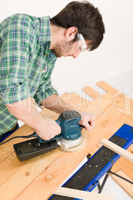 Home improvement - handyman sanding wooden floor