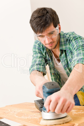 Home improvement - handyman sanding wooden floor