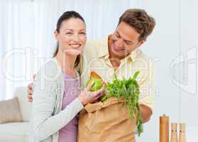Happy couple coming back from the market with fruits , vegetable