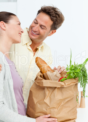 Lovely couple coming back from the market with vegetables