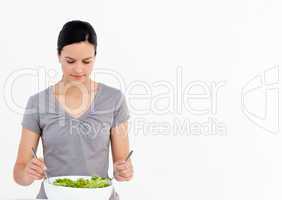 Pretty woman preparing a salad with tomatoes in the kitchen