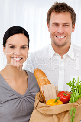Portrait of a happy couple at home after shopping