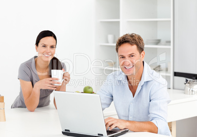 Portrait of a  man working on the laptop while his girlfriend is