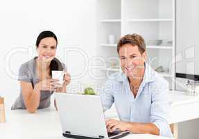 Portrait of a  man working on the laptop while his girlfriend is