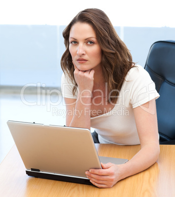Portrait of a serious businesswoman working on laptop