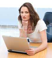 Portrait of a serious businesswoman working on laptop