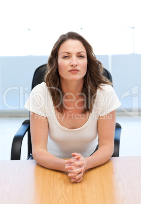 Thoughtful businesswoman sitting at a table