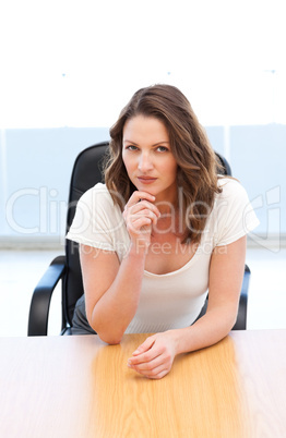 Pensive businesswoman sitting at a table