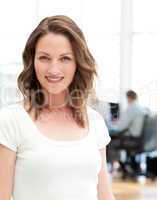 Relaxed businesswoman posing in front of her team