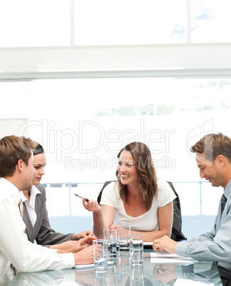 Cheerful manager talking to her team during a meeting