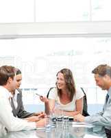Cheerful manager talking to her team during a meeting