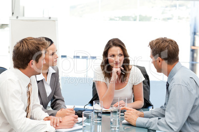 Charismatic businesswoman at a table with her team