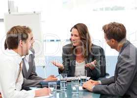 Attractive businesswoman laughing with her team