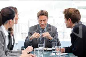 Serious manager at a table with his team during a meeting