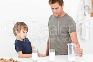 Cute dad and son drinking milk together