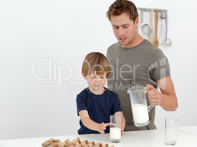 Handsome man giving milk to his son