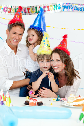 Portrait of cute children with their parents during a birthday p