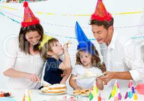 Beautiful mom serving a birthday cake to her family