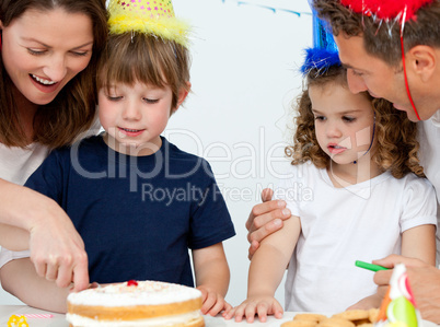 Mom and son cutting a birthday cake together