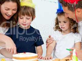 Mom and son cutting a birthday cake together