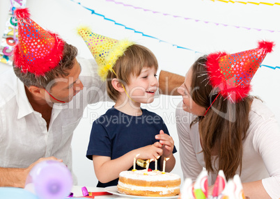 Attentive parents celebrating their son's birthday