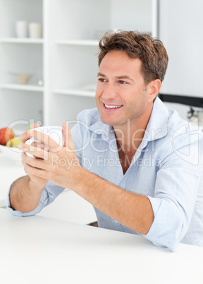 Happy man drinking coffee during a break