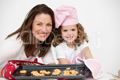 Lovely mother and daughter holding a plate with biscuits