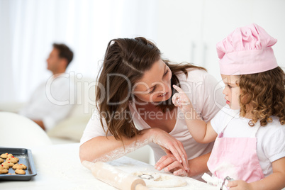 Mother and daughter having fun in the kitchen