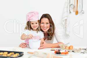 Portrait of an adorable mother and daughter preparing a daugh to