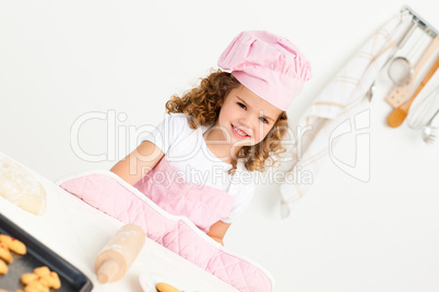 Portrait of a cute girl preparing cookies