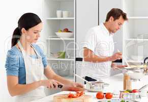 Couple preparing bolognese sauce and pasta together