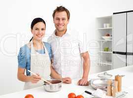 Portrait of a happy couple preparing a bolognese sauce