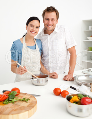 Happy couple preparing a bolognese sauce together