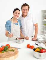 Happy couple preparing a bolognese sauce together