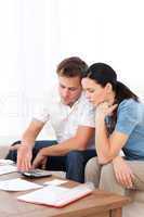 Desperate couple doing their account sitting on the sofa