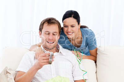 Happy man looking at a watch given by his girlfriend
