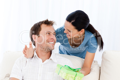 Happy man receiving a present from his girlfriend
