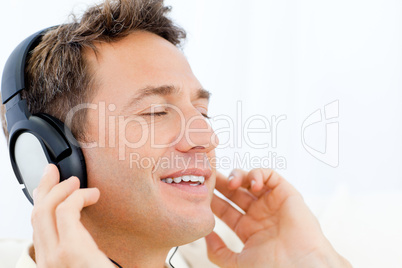 Peaceful man listening music on the sofa